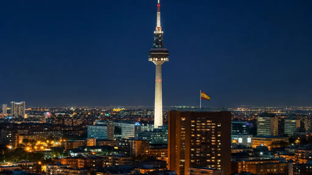 silvia intxaurrondo: torre de televisión iluminada sobre las luces nocturnas de Madrid