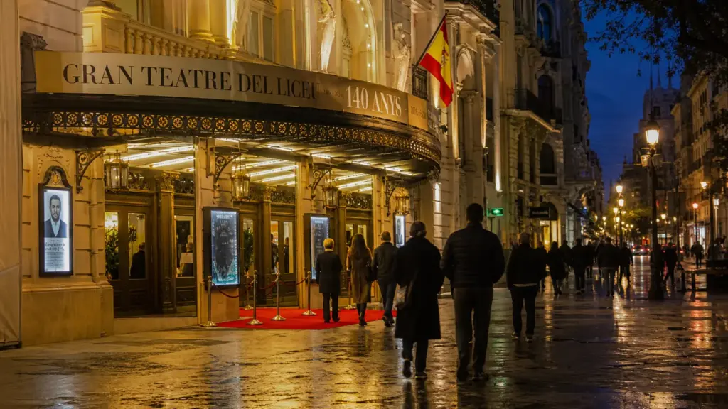 premio actúa 2026: entrada iluminada de un teatro con alfombra roja y figuras lejanas de espaldas al anochecer